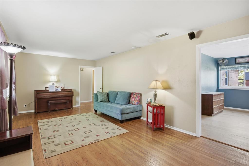 1004 Usher Street Benbrook, TX 76126 - Photo 8 of 25 a bedroom with furniture and a wooden floor