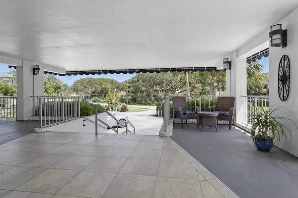 a view of a chairs and table in patio