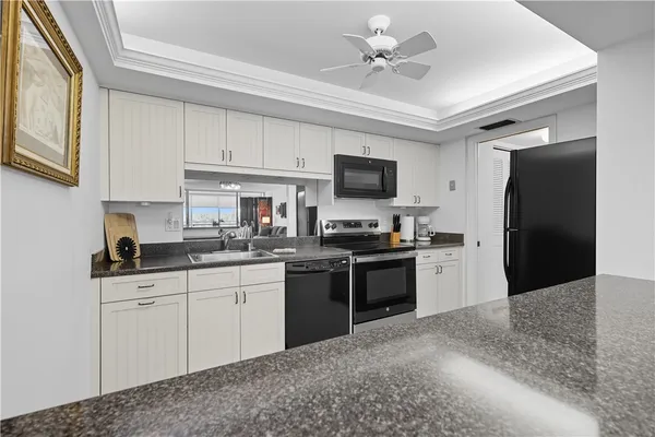a kitchen with a sink appliances and cabinets