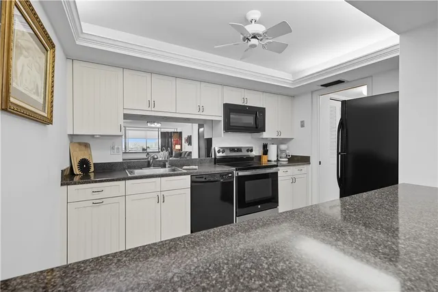 a kitchen with a sink appliances and cabinets