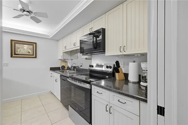 a kitchen with stainless steel appliances granite countertop a stove sink and cabinets