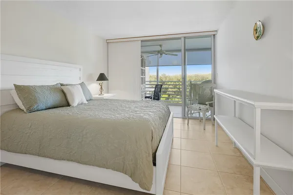 a bedroom with a large bed and a night stand