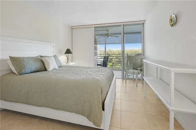 a bedroom with a large bed and a night stand