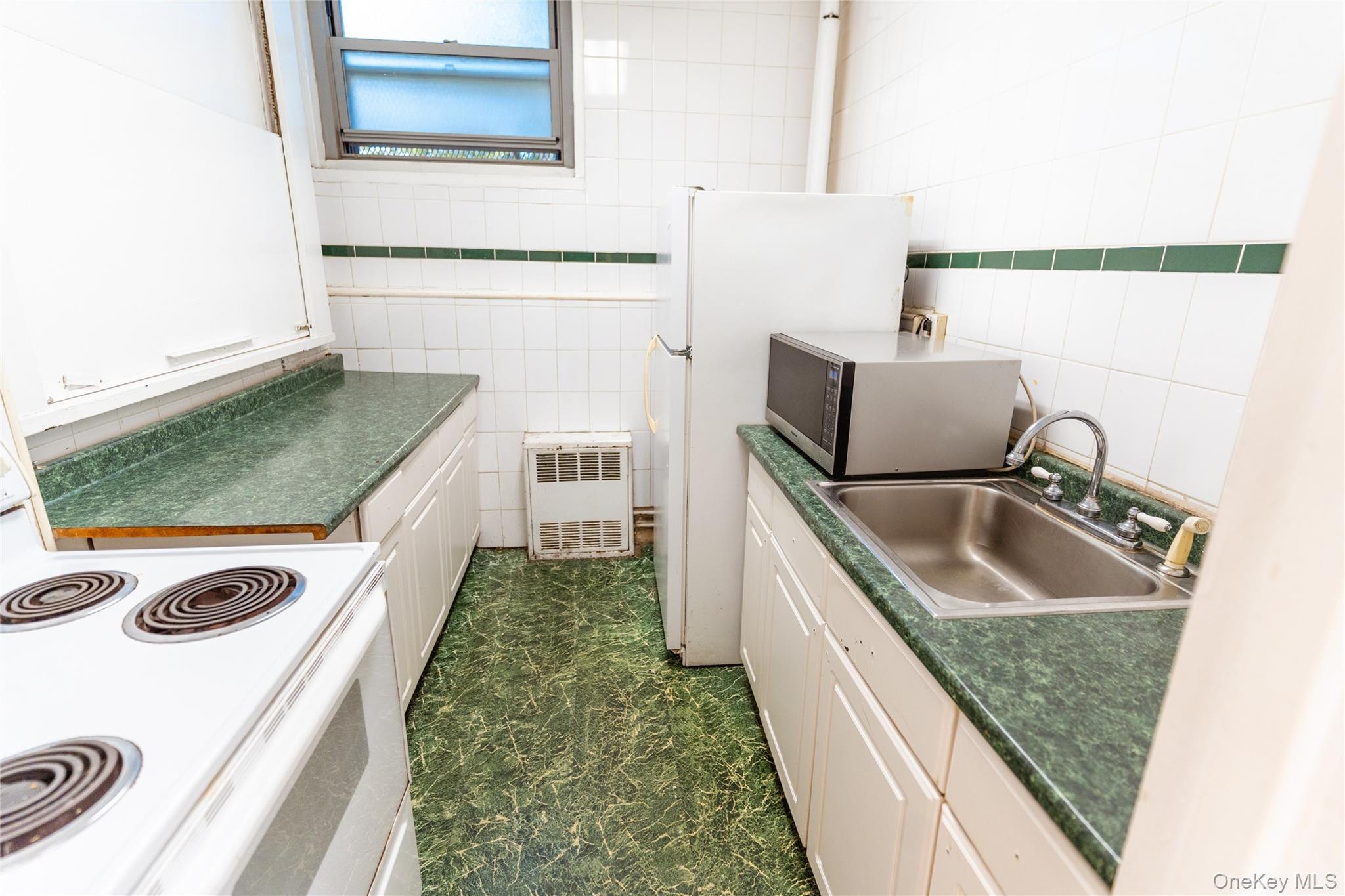 3410 De Reimer Avenue, Unit 7F Bronx, NY 10475 - Photo 17 of 23 a kitchen with a sink stove and refrigerator