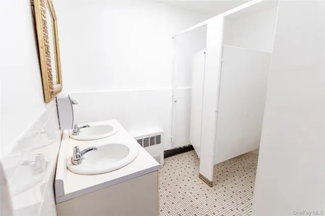 a bathroom with a sink a toilet and a mirror