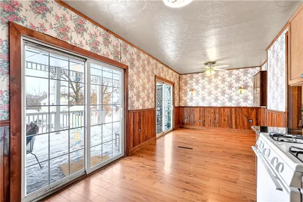 a view of balcony with a large window and wooden floor