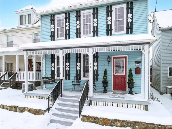 a view of a building with a bench in front of house