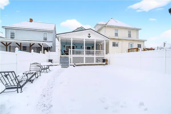 a view of a house with a snow in the background