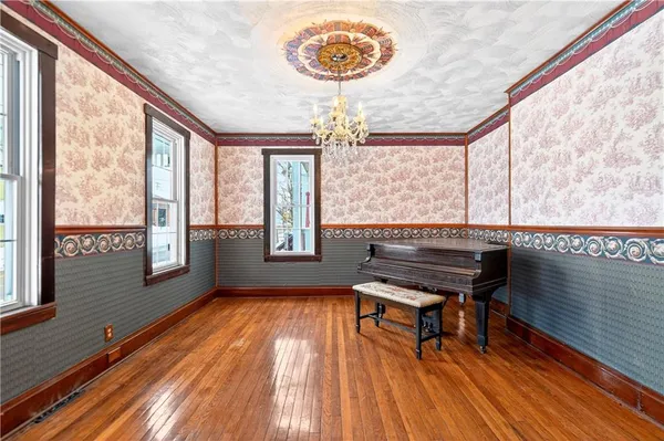 a view of a room with a window and wooden floor