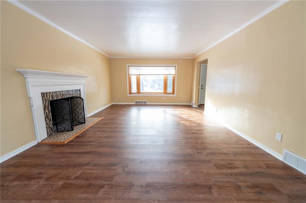 528 Wimer Circle Pittsburgh, PA 15237 - Photo 11 of 48 an empty room with wooden floor fireplace and windows