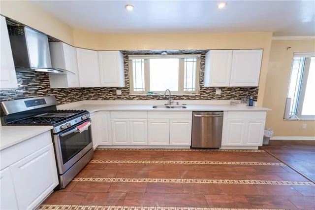 a kitchen with a stove top oven sink and cabinets