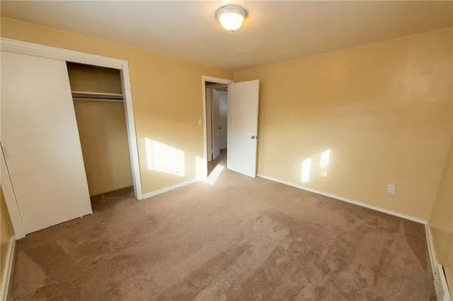 an empty room with a empty space and a window