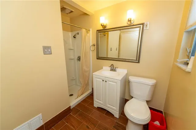 a view of a hallway with wooden floor and a window