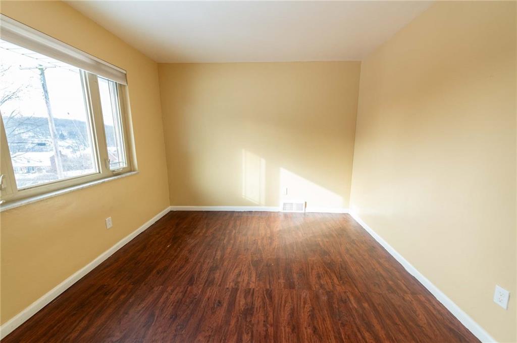 528 Wimer Circle Pittsburgh, PA 15237 - Photo 7 of 48 an empty room with wooden floor and windows