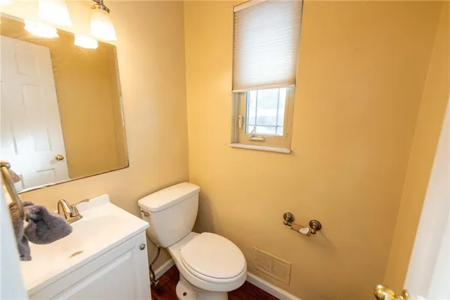 a white toilet sitting next to a bathroom sink