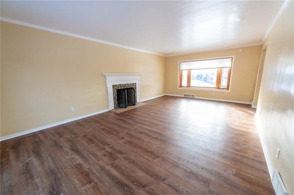 528 Wimer Circle Pittsburgh, PA 15237 - Photo 10 of 48 an empty room with wooden floor fireplace and windows