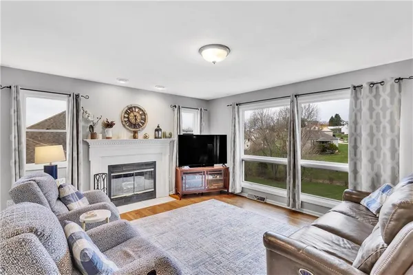 a living room with furniture a flat screen tv and a fireplace