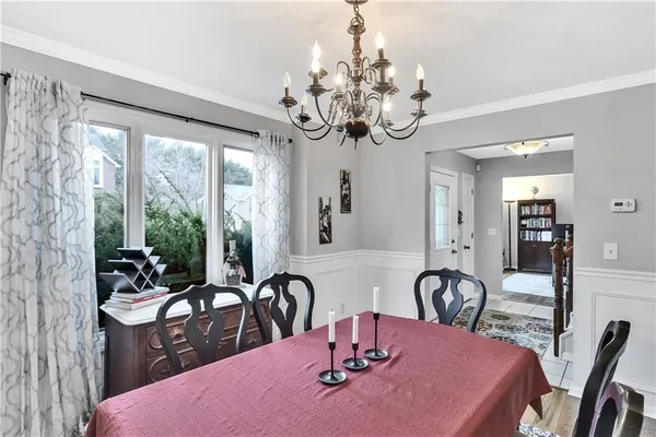 a view of a dining room with furniture and chandelier