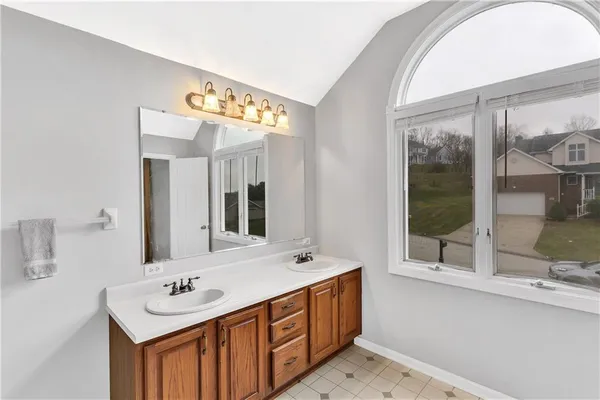 a bathroom with a granite countertop sink toilet a mirror and bathtub