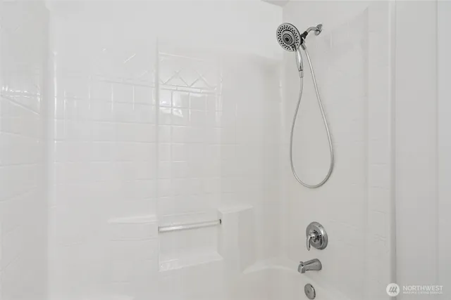 a view of an empty room with a ceiling fan
