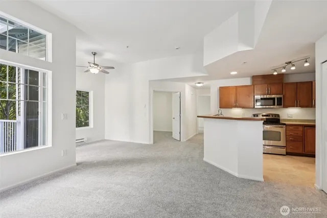 a view of kitchen with kitchen island wooden floor center island and stainless steel appliances