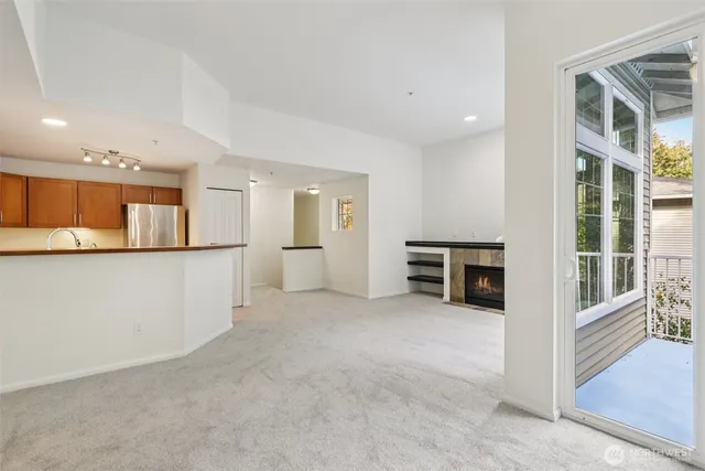 a view of a kitchen with furniture and an empty room