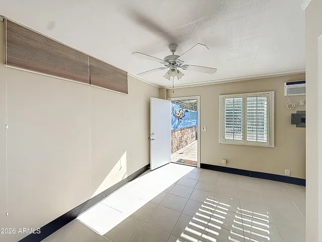 a view of a livingroom with wooden floor and staircase