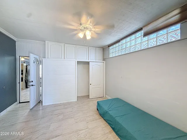 a spacious bedroom with a bed and a window