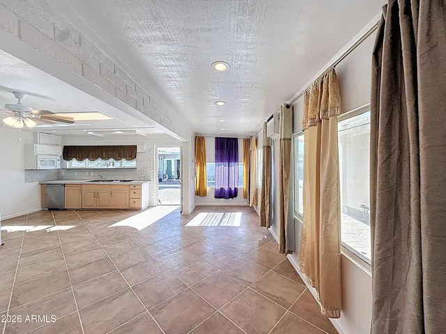 a view of a big room with windows and kitchen view
