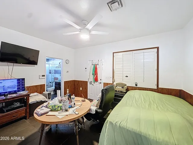 a view of a hallway with a bedroom and a bathroom