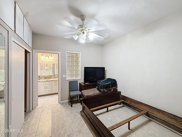 a kitchen with a refrigerator cabinets and wooden floor