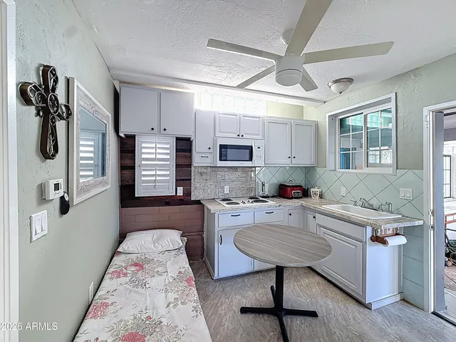 a spacious bedroom with a bed and a desk in it