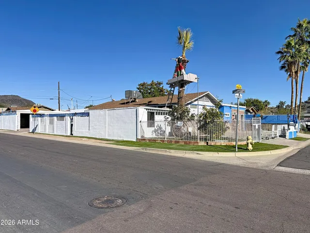 a front view of a house with a garden and yard