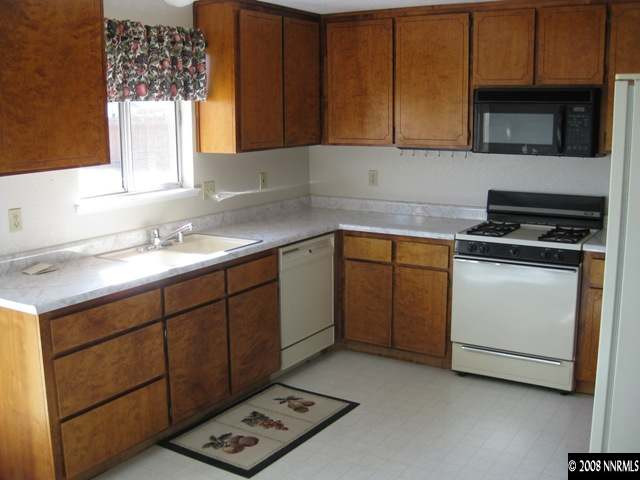 276 River Boat Road Dayton, NV 89403 - Photo 3 of 8 a kitchen with a sink stove and microwave