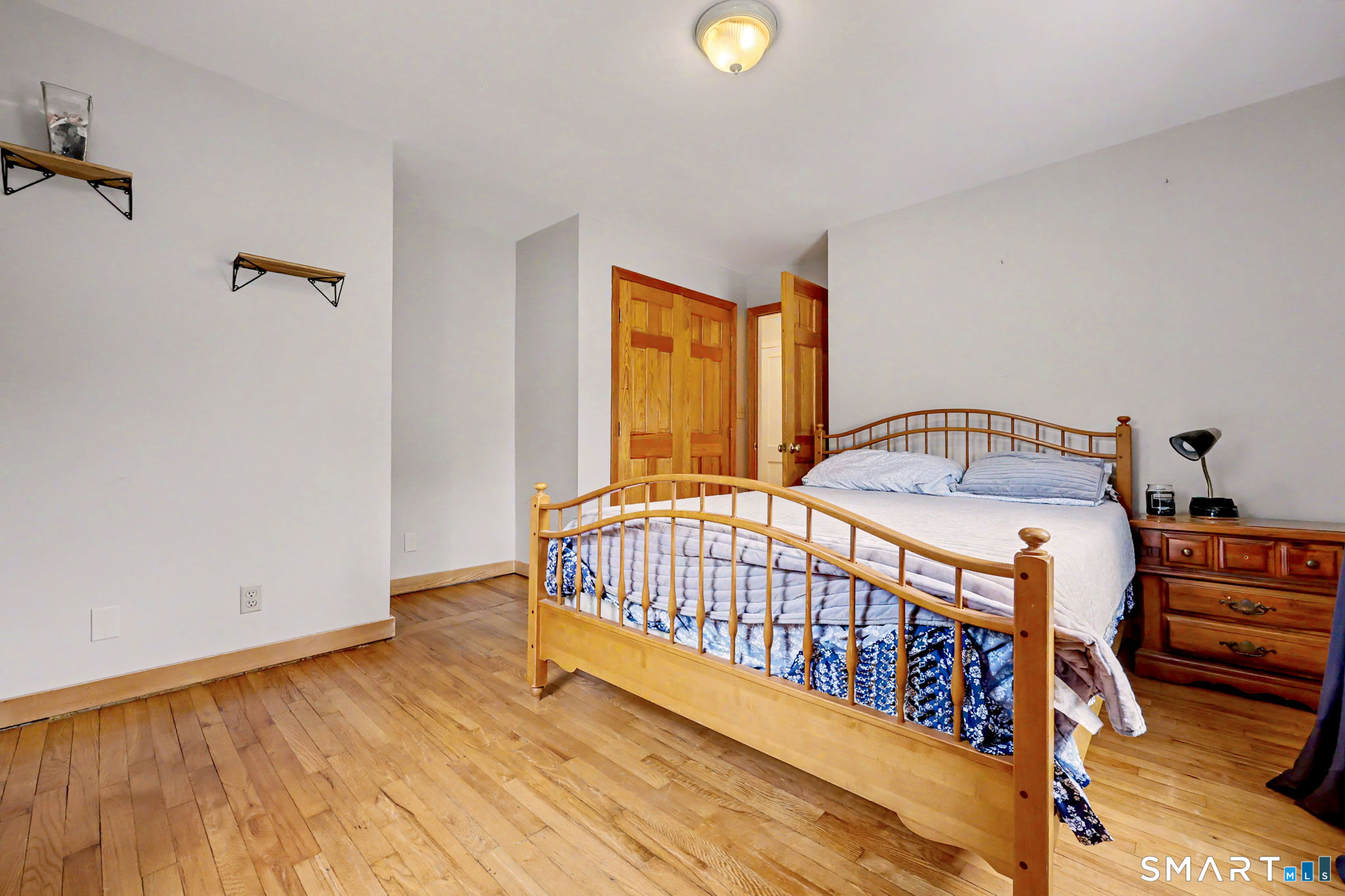7 Merrill Road Trumbull, CT 06611 - Photo 12 of 40 a bedroom with a bed and wooden floor
