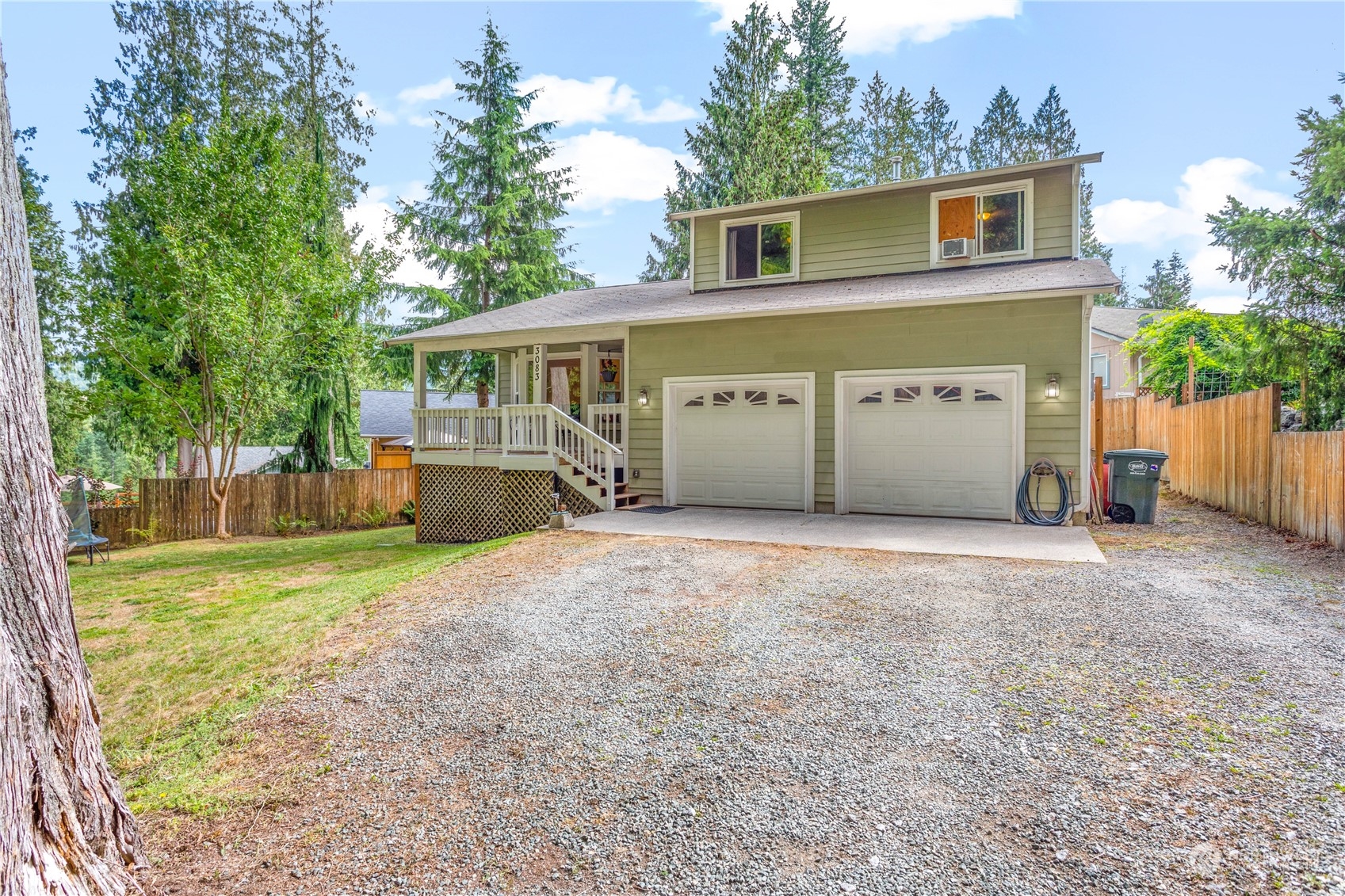 front view of a house with a yard and a garage