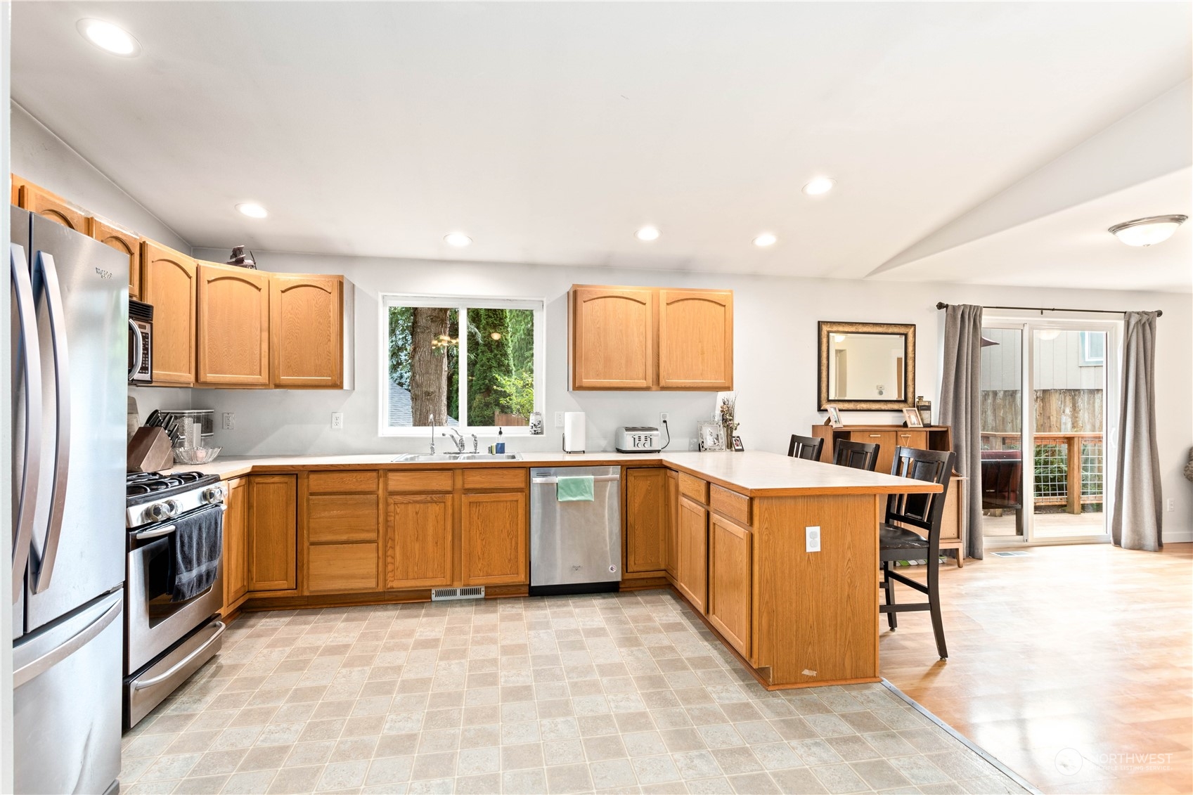 3083 Ash Way Sedro-Woolley, WA 98284 - Photo 11 of 36 a large kitchen with cabinets wooden floor and stainless steel appliances