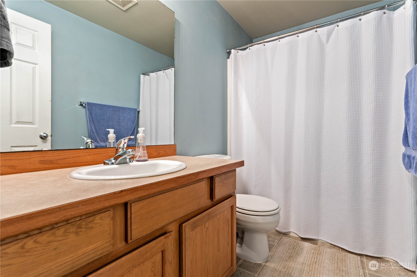 3083 Ash Way Sedro-Woolley, WA 98284 - Photo 24 of 36 a bathroom with a granite countertop sink and a mirror