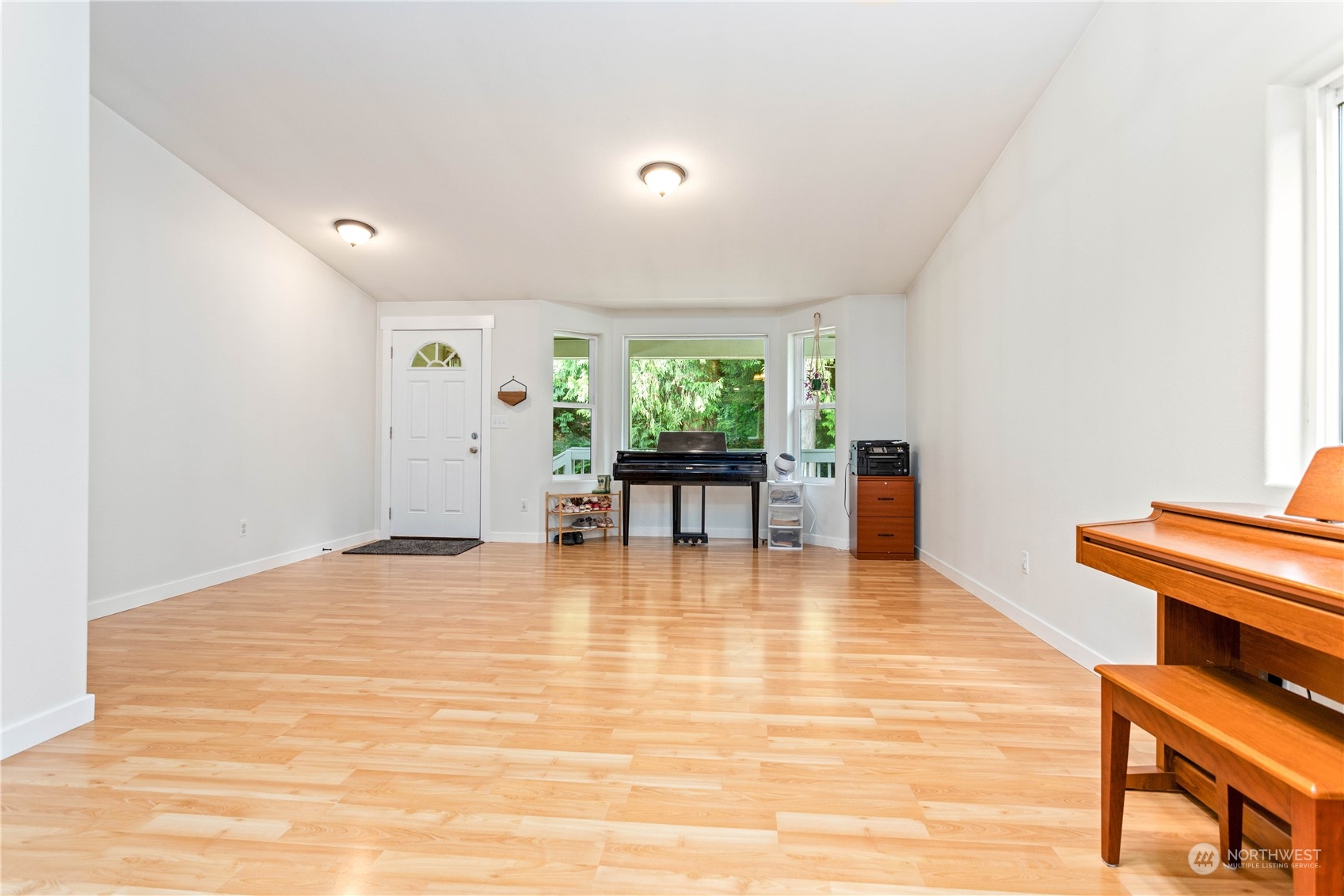 3083 Ash Way Sedro-Woolley, WA 98284 - Photo 6 of 36 a view of an empty room with window and wooden floor