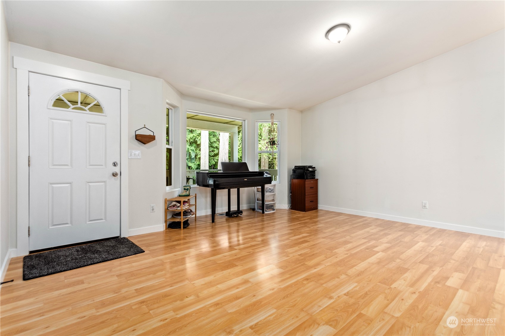 3083 Ash Way Sedro-Woolley, WA 98284 - Photo 7 of 36 a view of an empty room with window and wooden floor