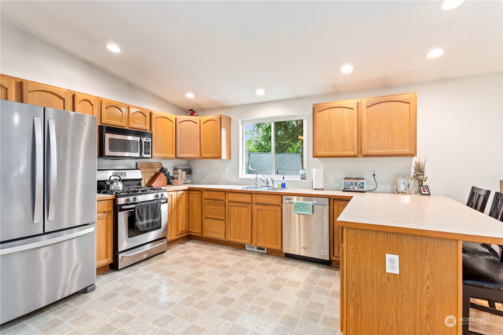 3083 Ash Way Sedro-Woolley, WA 98284 - Photo 8 of 36 a kitchen with stainless steel appliances granite countertop a refrigerator sink stove microwave and cabinets