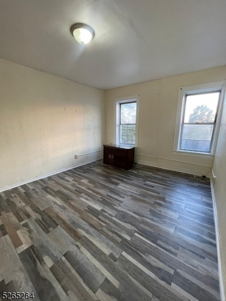 165 Augusta Street, Unit C8 Irvington, NJ 07111 - Photo 1 of 9 wooden floor in an empty room with a window