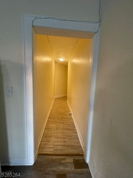 165 Augusta Street, Unit C8 Irvington, NJ 07111 - Photo 4 of 9 a view of a hallway with wooden floor