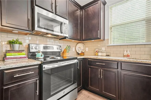 a view of walk in closet with clothes