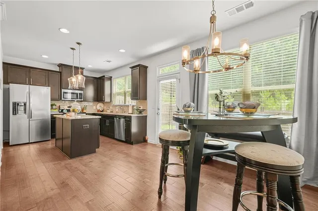 a very nice looking dining room with a table and chairs in it