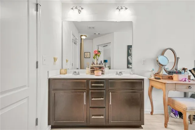 a spacious bedroom with a bed and a chandelier
