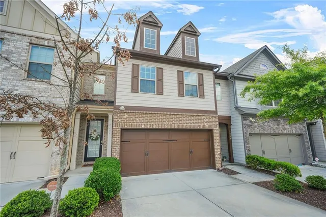 a living room with furniture kitchen view and a fireplace