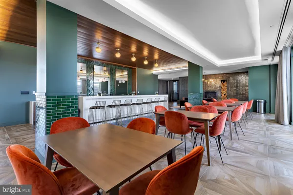 a dining room with stainless steel appliances furniture and window
