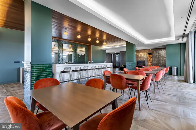 a dining room with stainless steel appliances furniture and window