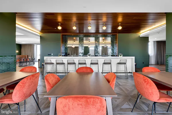 a view of a patio with dining table and chairs with wooden floor